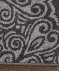 Close-up of floral gray design on non slip stair treads carpet, part of peel and stick set of 13, floor safe for wood tile.