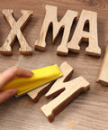 Using Go To 3.5 Inch By 1 Inch Sanding Block With 70 Piece Sandpaper Set on wooden letters for detail sanding.