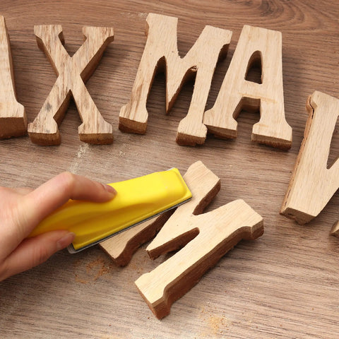 Using Go To 3.5 Inch By 1 Inch Sanding Block With 70 Piece Sandpaper Set on wooden letters for detail sanding.