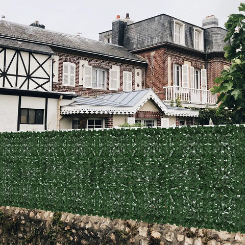 Faux Ivy Privacy Fence Screening Expandable Outdoor Greenery Roll Easy Install For Garden And Patio Realistic Fake Hedge Wall Panels 157.5 By 39.4 Inches Ideal Gate Cover And Balcony Yard Decor in front of a brick house.