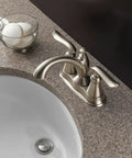 Linden Centerset Bathroom Faucet In Brushed Nickel With Diamond Seal Technology next to a white sink on granite countertop