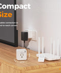 Remote Control Outlet Plug Set With One Remote And Two Outlets, compact size, on wooden surface with router and TV