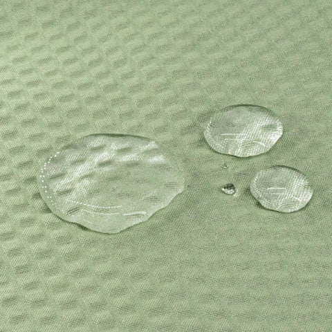 Close-up of water droplets on sage green textured polyester fabric of Sage Green Cloth Shower Curtain Liner With 2 Magnets, Textured Polyester For Spa Like Feel, Soft Hotel Quality Waterproof, Lightweight And Machine Washable, 72x84 Inch.