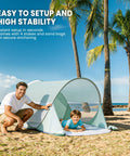 Go To Easy Pop Up Beach Shelter For 1 To 2 People With UPF Fifty Plus UV Protection Set Up In Seconds on a sunny beach with palm trees.