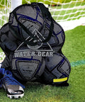 Large Mesh Tote Bag With Zipper For Swim Gear, Balls And Aqua Equipment on grass by soccer goal with sports shoes