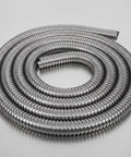 Heavy Duty Flexible Stainless Steel Electrical Wiring Conduit With Dang Smooth Burr Free Bore coiled on a smooth surface.