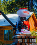 Motorized Fertilizer Spreader Broadcast 4 Gallon Capacity For Lawn Care shown outdoors on a brick stand