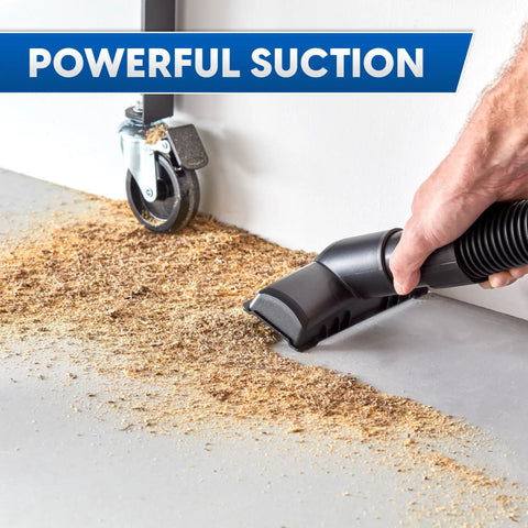 Heavy Duty 8 Gallon Wet Dry Shop Vac Delivering 75 Cfm Raw Heavy Lifting Suction For Serious Garage Cleanups Includes 17 Foot Extender Hose Seven Tough Cleaning Tools And Wide Base Rollers For True Workhorse Simplicity, vacuuming sawdust on concrete with hand-held nozzle.