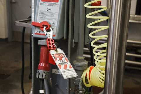 Heavy-Duty Lockout Hasp With Vinyl-Coated Handle 1.5 Inch Jaw High Tensile Steel 6 Lock Holes 12 Pack in use on equipment