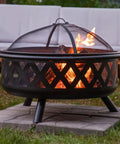 Crossweave Outdoor Wood Burning Fire Pit For Patio Or Yard 36 Inch Round Black Fire Pit with spark screen at backyard gathering