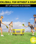 Four players engaged in Pickle 360 Outdoor Paddle Ball Game Set For Lawn Beach And Backyard No Court Needed 2 On 2 Family Friendly Fun