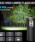 Beast Bright Rechargeable LED Flashlight With Dual Switch 13000 Lumens Of Power shown in hand highlighting trees at night.