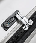 Close-up of silver DELSEY Paris titanium hardside luggage lock with TSA dial