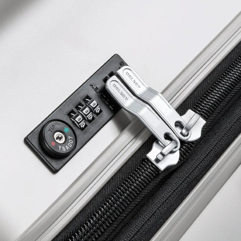 Close-up of silver DELSEY Paris titanium hardside luggage lock with TSA dial