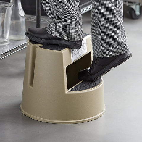 Person using Mobile Heavy Duty Plastic Step Stool With Wheels, 16 Inch Beige, 350 Pound Capacity, Nonslip Steps in an indoor setting.