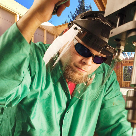 Worker wearing Hellraiser Safety Glasses With Blue Mirror Lenses And Black Frame For Outdoor Work under helmet shield