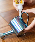 Applying Super Glue Gel Clear 20 Gram Pack Of 2 All Purpose Fast Setting Adhesive on metal watering can handle
