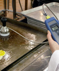 Weighted Griddle Surface Thermocouple Probe Type K For Grills And Flat Tops Minus Forty To Five Hundred Degrees Fahrenheit Range Ultra Fast Two Second Read Time On Oiled Surfaces 2.5 Inch Diameter Flexible Armor With PTFE Coated Shaft in use on a griddle cooking eggs.