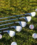 Golf clubs on grass with 8 Pack Precision Golf Ball Marker Set With 4 Color Marking Stencils And 4 Vibrant Markers For Quick Alignment