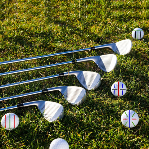 Golf clubs on grass with 8 Pack Precision Golf Ball Marker Set With 4 Color Marking Stencils And 4 Vibrant Markers For Quick Alignment