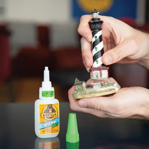 Person using Clear Gel Super Glue For All Purpose Bonding Fast Setting And No Run Formula Great For Glass Plastic Wood Ceramic And More Ideal For DIY Projects And Household Repairs 20 Gram Pack on a lighthouse model.