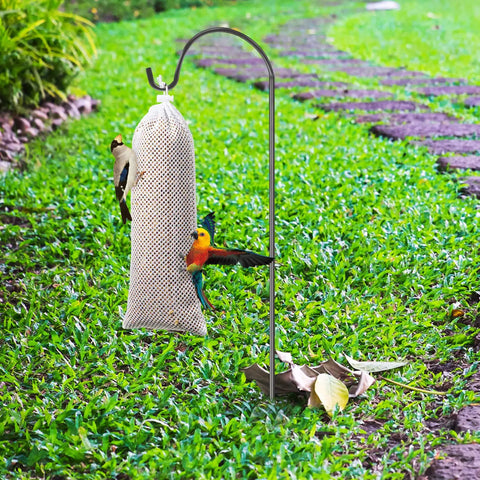 Three Pack Finch Sock Feeders Budget Friendly With Thistle Seed Bags For Outdoors And Garden on metal pole in grassy area