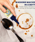Secret Spot Remover For Clothes Chlorine Free Toxin Free Stain Remover For Fabric That Eliminates Oil Paint Blood And Pet Stains Without Damaging Color Safe On Most Fabrics Gentle Non Bleach Formula 2 Ounce Bottle being applied on stained fabric next to a spoon.