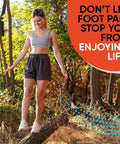 Woman balancing on a log in the forest, wearing athletic clothing. "Don't let foot pain stop you from enjoying life" text overlay.