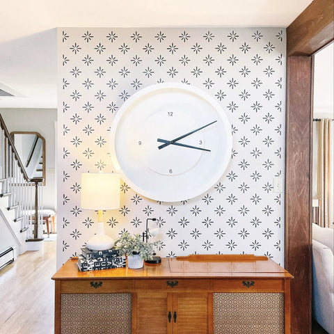Starburst Geometric Wall Stencil Kit 2 Pack Of 16.5 X 31.5 Inch Stencils for large starburst pattern on living room wall with clock.