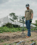 Man using Rugged Heavy Duty Digging Fork With Carbon Steel Head And Fiberglass Core, Short Handle With No-Slip H-Grip in a garden