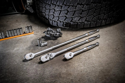 Set of three One Half Inch Drive Teardrop Ratchets With Full Polish Chrome Finish next to mechanical tools on concrete floor