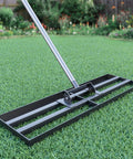 Beast Heavy Duty Lawn Leveling Rake With 30 Inch By 10 Inch Head And 78 Inch Adjustable Stainless Steel Handle on green grass