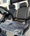 Two Seater Electric Golf Cart With Independent MacPherson Strut Suspension And Tuned Coil Spring Shocks interior view of seats and steering wheel.