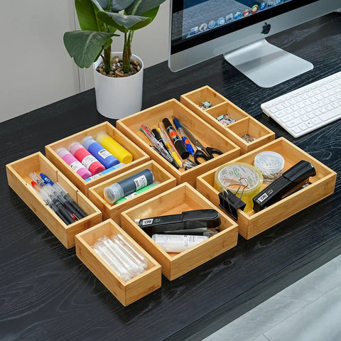 Bamboo Drawer Organizer Set Of 9 For Kitchen And Office, Crushes Junk Drawer Chaos While Keeping Cutlery Silverware Utensils Makeup And Desk Supplies Neatly Sorted In Bathrooms And More displayed on a desk with office supplies inside.