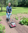Man using Upgraded 40cc 4 Cycle Tiller Mini Cultivator With 6 Forged Steel Tines Vertical Shaft Engine Anti Leak Lubrication in garden