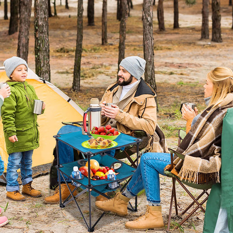 Family using Foldable Camping Table With Built In Cup Holders And Food Basket Ultra Lightweight Square Outdoor Picnic Table With Travel Bag