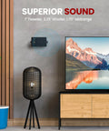 Three Way Indoor Outdoor Speaker System Pair For Home Theater And PA, wall-mounted next to TV, modern living room setting.