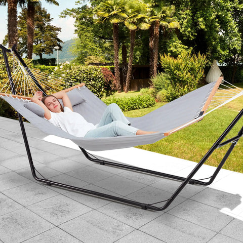 Heavy Duty Hammock Stand For Indoors And Outdoors, 660 Lb Capacity, Fits 9.6 To 14 Ft Hammocks, All Steel Frame, Built To Last Weatherproof Universal 2 Person Ready, Black, with person reclining in backyard
