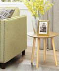 16 Inch Solid Rubber Wood Table Legs With M8 Hanger Bolts supporting a round table next to a sofa, highlighting tapered design.