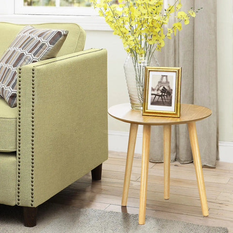 16 Inch Solid Rubber Wood Table Legs With M8 Hanger Bolts supporting a round table next to a sofa, highlighting tapered design.