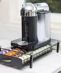 Vertuoline Coffee Pod Holder With Tempered Glass Drawer Deluxe Size Holds Up To 40 Pods For VertuoLine Capsules Keeps Your Countertop Organized And Clutter Free Boss Level Glass Drawer Organizer For Espresso Pods holding colorful coffee pods on a countertop.