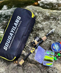 Kids Fishing Rod And Reel Combo Lightweight Telescopic Pole With Spincast Reel, tackle bag and lures on rock by river