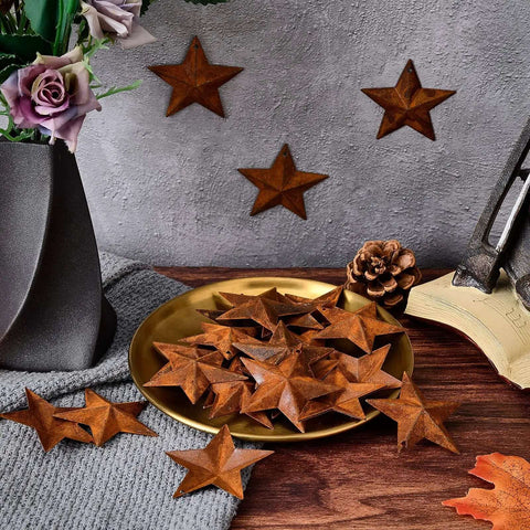Rusty Barn Star Set Thirty Pieces Two Inch Metal Stars For Crafts Rustic Primitive Accents on a table with flowers and decor