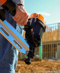 Close-up of Heavy Duty Five Piece Pneumatic Nailer And Stapler Kit held in hand, perfect for framing and DIY projects.