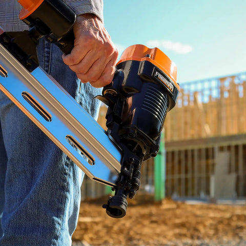 Close-up of Heavy Duty Five Piece Pneumatic Nailer And Stapler Kit held in hand, perfect for framing and DIY projects.