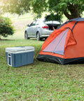 Top Notch 48 Quart Electric Cooler And Warmer With Wheels Grab And Go Thermoelectric Portable Fridge beside a camping tent.