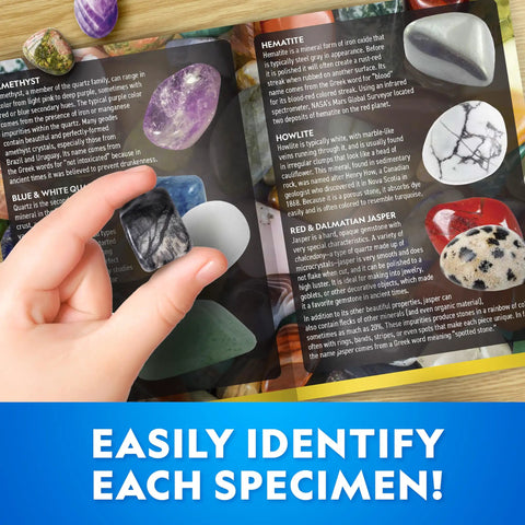 Child holding a gemstone over a guide showing minerals, part of Gigantic Gemstone Dig Kit For Kids Fun Excavate 50 Real Gems Adventure.