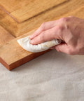 Applying Color Matched Wood Filler In Golden Oak No Sand Ready To Use 6 Oz to wood surface with cloth for seamless repair