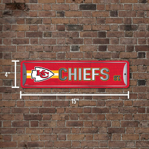 Official Kansas City Chiefs NFL Aluminum Metal Street Sign 4X15 Inch Durable Weatherproof All Indoor And Outdoor Wall Art Decor For Man Cave showcasing red design on a brick wall.