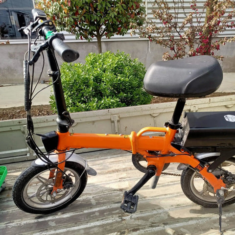 Orange folding electric bike with 16x2.50 tire and inner tube set for scooters ebikes BMX and kids bikes 65-305 size